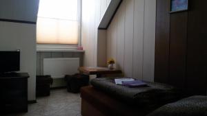 a room with a bed and a table and a window at Zajazd Malibu in Szypliszki