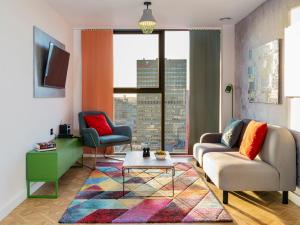 a living room filled with furniture and a window at Church Street by Supercity Aparthotels in Manchester