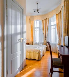 a bedroom with a bed and a dresser at Baskov in Saint Petersburg