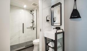 a bathroom with a shower and a sink and a toilet at Pestana Park Avenue in New York