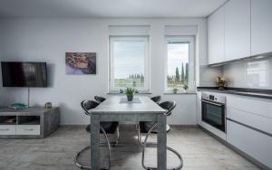 a kitchen with a table and chairs in a room at SOFIA house with apartment in Umag +12 photos