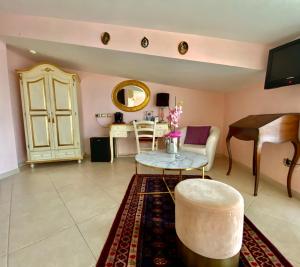 a living room with a piano and a table at Hotel Scilla in Scilla