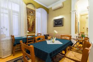 a dining room with a blue table and chairs at Baskov in Saint Petersburg