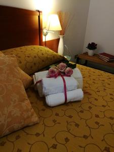 a hotel room with towels and roses on a bed at HOTEL PRINCIPE in Forlì