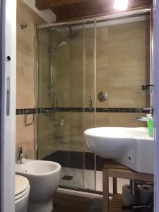 a bathroom with a shower and a sink and a toilet at La casa nel sole - Boutique B&B in Bari