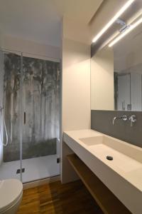 a bathroom with a toilet and a sink and a shower at San Domenico's Rooms in Matera