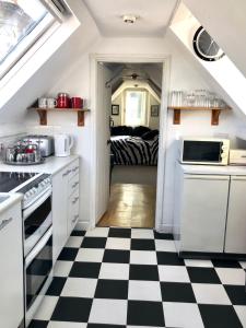 a kitchen with a black and white checkered floor at Lauras Townhouse Apartments Skylight Loft in Bath