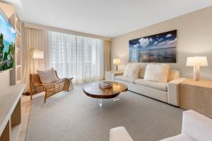 a living room with a couch and a table at 1 Bedroom Ocean View located at 1 Hotel & Homes Miami Beach -1012 in Miami Beach