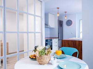a kitchen with a table with a basket of fruit at PREMIUM BEACH DESIGN - La Malagueta in Málaga