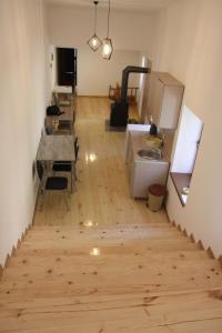 a room with wooden floors and a room with desks at Eka's guest house in Mestia