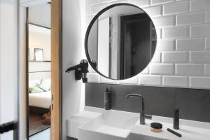 a bathroom with a sink and a mirror at ibis Brussels Centre Chatelain in Brussels