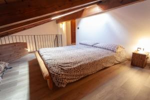 a bedroom with a bed and a wooden floor at Chalet Mew in La Thuile