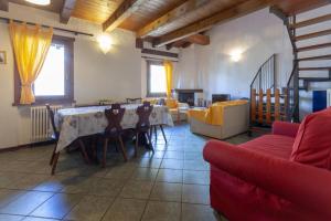 a living room with a table and chairs and a couch at Chalet Mew in La Thuile