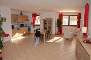 a kitchen and living room with a table and chairs at Villa Lipno Lake in Lipno nad Vltavou