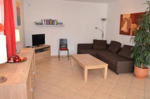 a living room with a couch and a table at Villa Lipno Lake in Lipno nad Vltavou