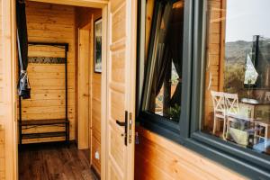 a door to a tiny house with a window at Daroszówka - Noclegi z Widokiem Solina in Solina