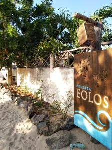 a sign for a hotel on the beach at Pousada Eolos in Barra Grande