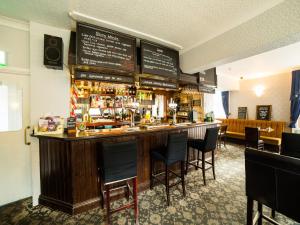 a bar in a restaurant with chairs around it at The Whistle and Flute in Barnetby le Wold