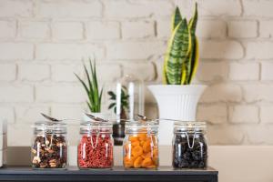 a table with four jars of food and a vase at ibis Brussels Centre Chatelain in Brussels