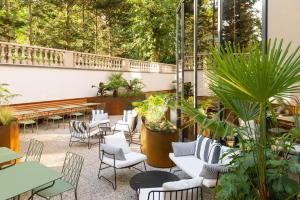 a patio with chairs and tables and plants at ibis Brussels Centre Chatelain in Brussels