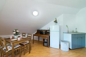 cocina con mesa y nevera en Apartamenty Fenix, en Kazimierz Dolny