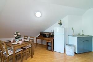 kuchnia ze stołem i lodówką w obiekcie Apartamenty Fenix w Kazimierzu Dolnym