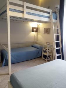 a bedroom with two bunk beds and a ladder at Blue sea in Aci Castello