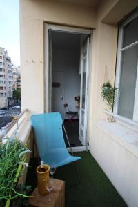 a blue chair on the balcony of a building at Le Lagon Marseillais in Marseille