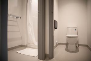 a white toilet sitting next to a bath tub at HI Jasper - Hostel in Jasper