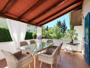 a dining room with a glass table and chairs at Holiday house Punta in Umag