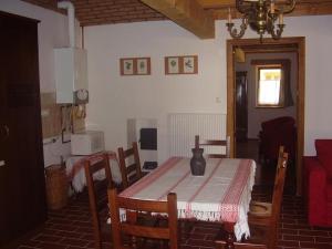 a dining room table with a vase on top of it at Martonvendeghaz 1 in Erdeimajor