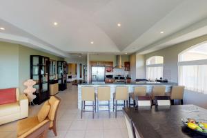 a kitchen and living room with a table and chairs at Peninsula 64 Penthouse in Guanacaste