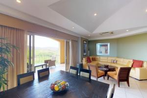 a living room with a couch and a dining room at Peninsula 64 Penthouse in Guanacaste