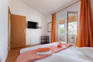 a bedroom with a large bed with towels on it at Apartment A4 Tonka in Igrane