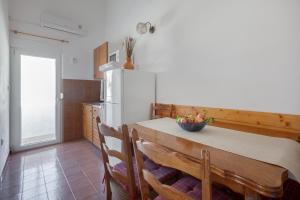 a kitchen with a table and a white refrigerator at Apartment A4 Tonka in Igrane