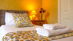 a bedroom with a bed with towels on it at Arrandale Guest House in Edinburgh