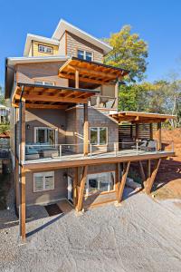 a house with a large deck in front of it at Upstream Bachelorette in Asheville