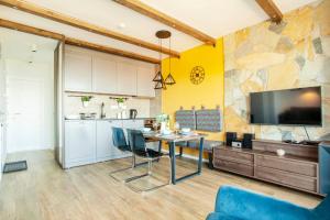 a kitchen and dining room with a table and a tv at Srebrna Petica in Kopaonik