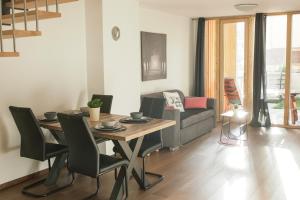 a living room with a table and a couch at Ski and Bike Apartment Rušovc in Kranjska Gora