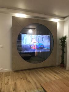 a tv in a wall with a car on it at DEAUVILLE STAR LUXE in Deauville