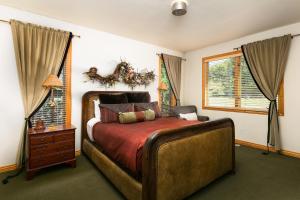 a bedroom with a large bed and two windows at Park City Homes by White Pines Solamere in Park City
