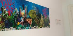 a painting of a reef on a wall at Michela Home in Camposano