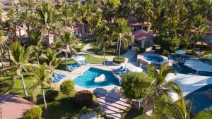 an aerial view of a resort with palm trees and a pool at Buena Vista Oceanfront & Hot Springs Resort in Buenavista