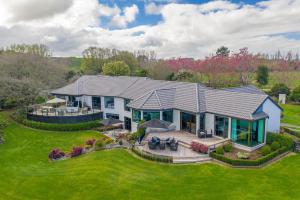 an aerial view of a home with a roof at Lakeview Lodge Karapiro in Cambridge