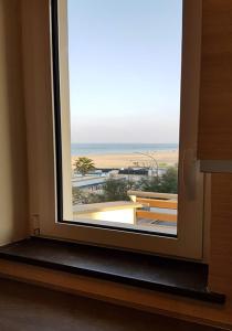 a window in a room with a view of the beach at Residenza Adriatica 2 in Roseto degli Abruzzi