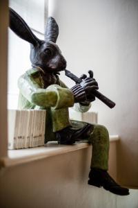 a statue of a rabbit playing a violin at Linthwaite House Hotel in Bowness-on-Windermere