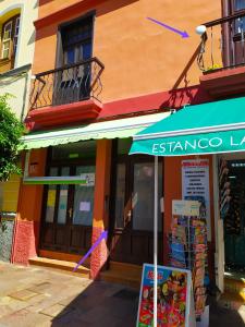 a store with a blue awning in front of a building at Apartamento La Peatonal in San Sebastián de la Gomera