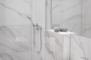 a bathroom with a shower with a towel on a counter at Vienna City Apartments - Metro 1160 Vienna in Vienna