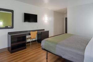a hotel room with a bed and a desk and a television at Motel 6-Duncanville, TX - Dallas in Duncanville