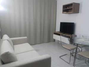a living room with a couch and a table and a television at Casa Dorotea in Playa del Cura